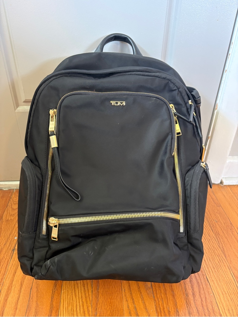 Tumi Voyageur Celina Black Backpack with Gold Hardware and Multiple Zip Pockets
